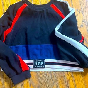 P.E Nation cropped sweatshirt. Black, navy band, red and white trim.